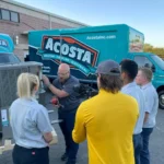 a group of people standing around a machine